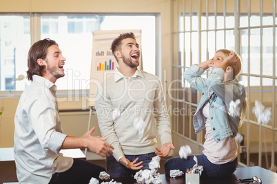 Business people playing with paper balls