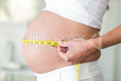 Midsection of woman with measuring tape
