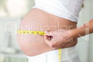 Midsection of woman with measuring tape