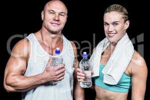 Portrait of confident athlete man and woman with water bottle