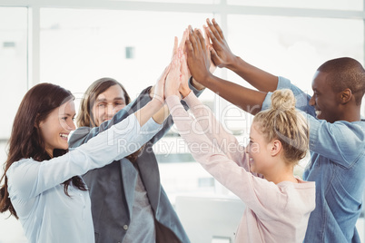 Smiling business team giving high five