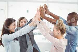 Smiling business team giving high five