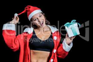 Portrait of female athlete in Christmas costume and holding gift