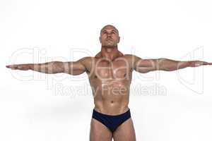 Muscular man with arms outstretched