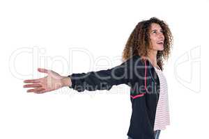 Happy young woman with arms outstretched