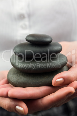 Woman hands holding pebbles