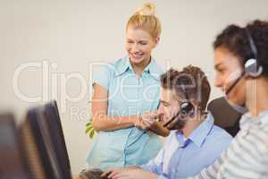 Businesswoman looking at employee working