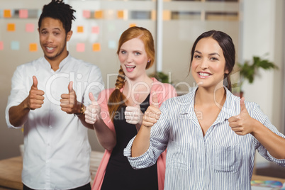Business people showing thumbs up
