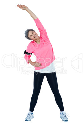 Mature woman listening music while stretching