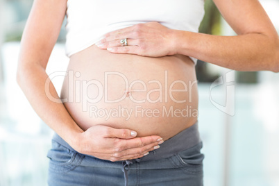 Midsection of woman with hands on belly
