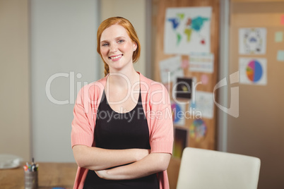 Smiling businesswoman with arms crossed