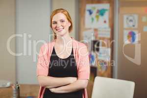 Smiling businesswoman with arms crossed