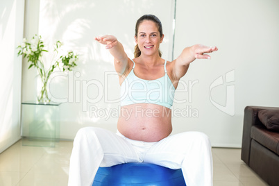 Portrait of woman exercising on ball