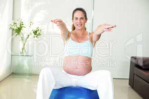 Portrait of woman exercising on ball