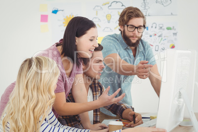 Business professionals looking at computer