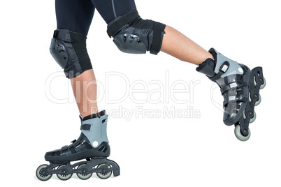 Woman inline skating against white background