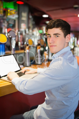 Portrait of cnfident man using laptop