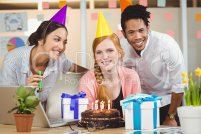 Businesswoman celebrating birthday with colleagues