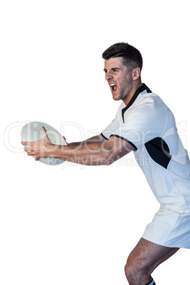 Man holding rugby ball and screaming