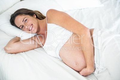 High angle view of happy woman on bed