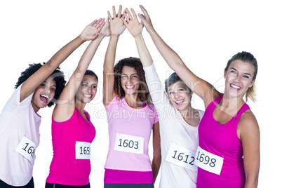 Portrait of smiling athletes putting their hands together with a