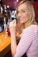 Portrait of happy woman with drink holding straw