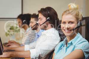 Portrait of smiling businesswoman in call center