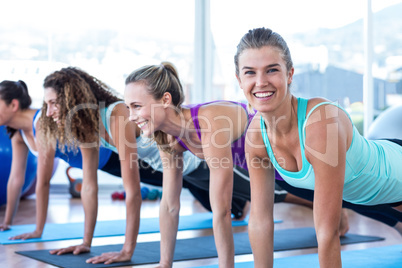 Portrait of a happy woman with friends in fitness studio