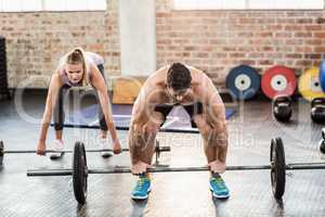 Two fit people working out at crossfit session
