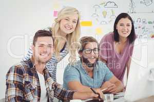 Portrait of cheerful  business professionals working at computer