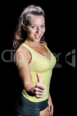 Portrait of cheerful athlete showing thumbs up