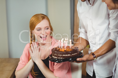 Happy woman looking at cake