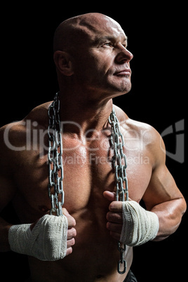 Muscular man holding chain