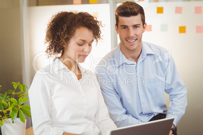 Businessman sitting by female colleague