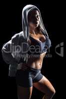 Portrait of sexy athlete in hood with hand on hip
