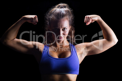 Portrait of confident bodybuilder flexing muscles