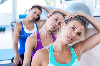 Beautiful woman in fitness studio doing head exercise