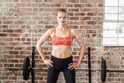 Portrait of serious fit woman looking at camera