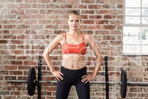 Portrait of serious fit woman looking at camera