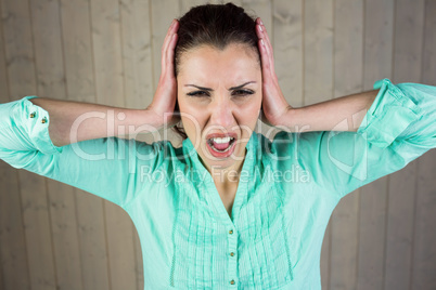 Woman screaming with head in hands