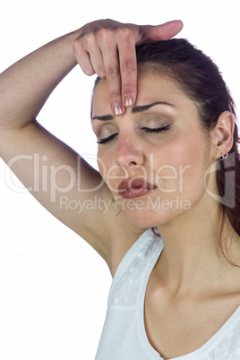 Woman with eyes closed white touching forehead