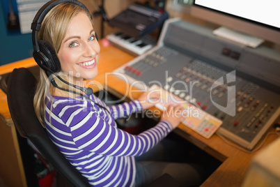 Happy radio host wearing headphones