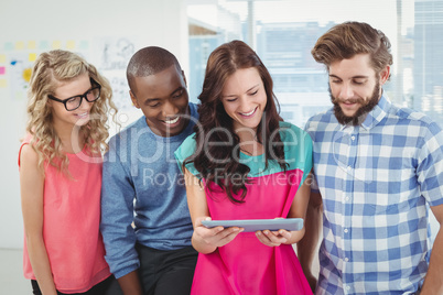 Smiling business professionals using digital tablet