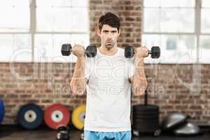 Portrait of muscular man lifting dumbbells