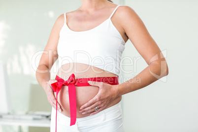 Midsection of woman with wrapped ribbon