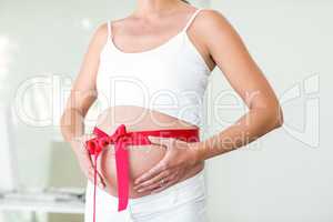 Midsection of woman with wrapped ribbon