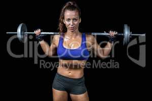 Portrait of confident fit woman lifting crossfit