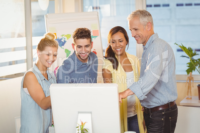 Business people using computer in meeting room