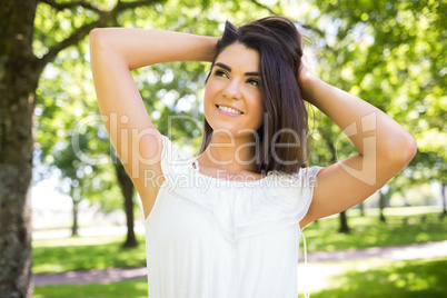 Portrait of young thoughtful woman with hand in hair