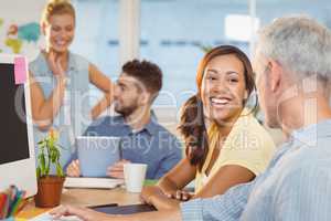 Businesswoman interacting with male colleague